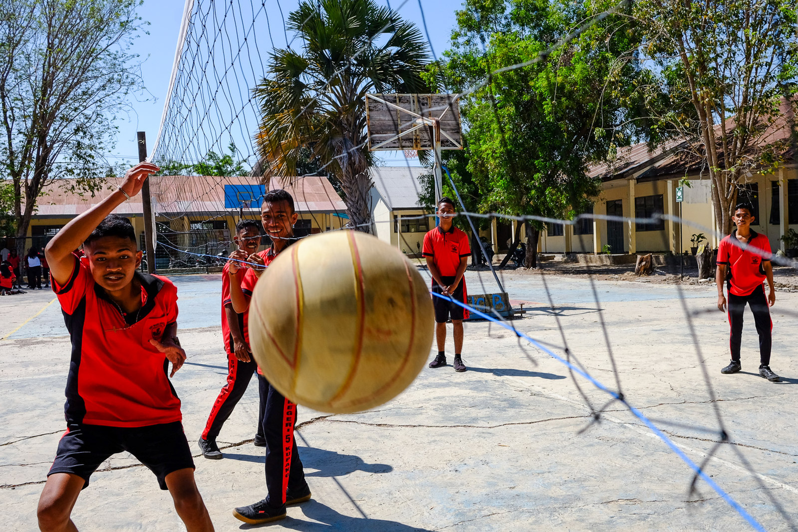 High school students at SMAN 5 play a game of volleyball during PE class on September 11, 2019 in Kupang, Indonesia.