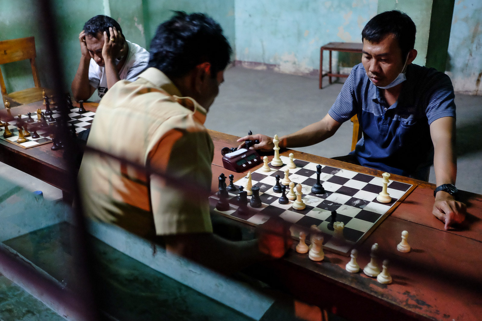 Locals play chess in the clubhouse of the local chapter of PERCASI, a nationwide chess club, on October 14, 2020 in Kupang, Indonesia.