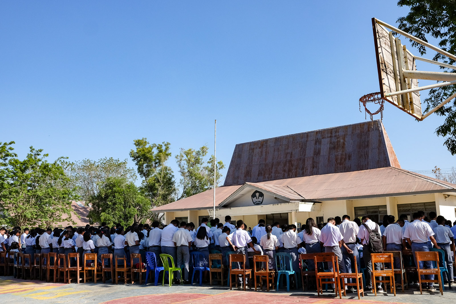 Protestant students stand in prayer during a Friday morning service at SMAN 5 on October 4, 2020 in Kupang, Indonesia. Elsehwere on campus, Catholic and Muslim students gathered for their own religious services.