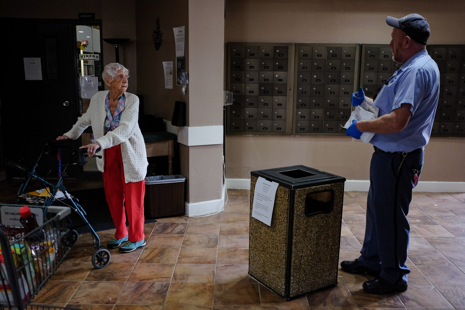 Mark Swan, a USPS letter carrier and President of the National Association of Letter Carrier’s 74th branch in Saginaw, chats with a resident of a high-rise apartment building he had just delivered mail to on Saturday, April 25, 2020 in Saginaw, Mich.