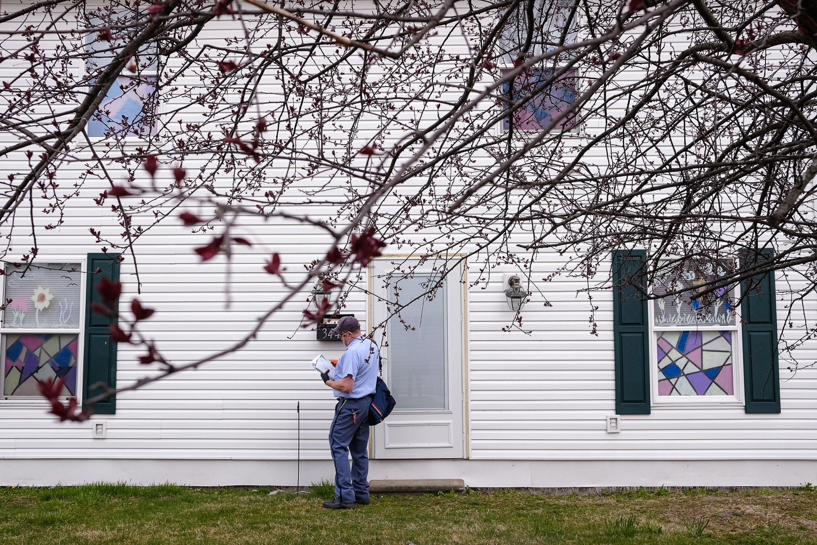 Mark Swan, a USPS letter carrier and President of the National Association of Letter Carrier’s 74th branch in Saginaw, delivers mail on foot on Saturday, April 25, 2020 in Carrollton Township, Mich.