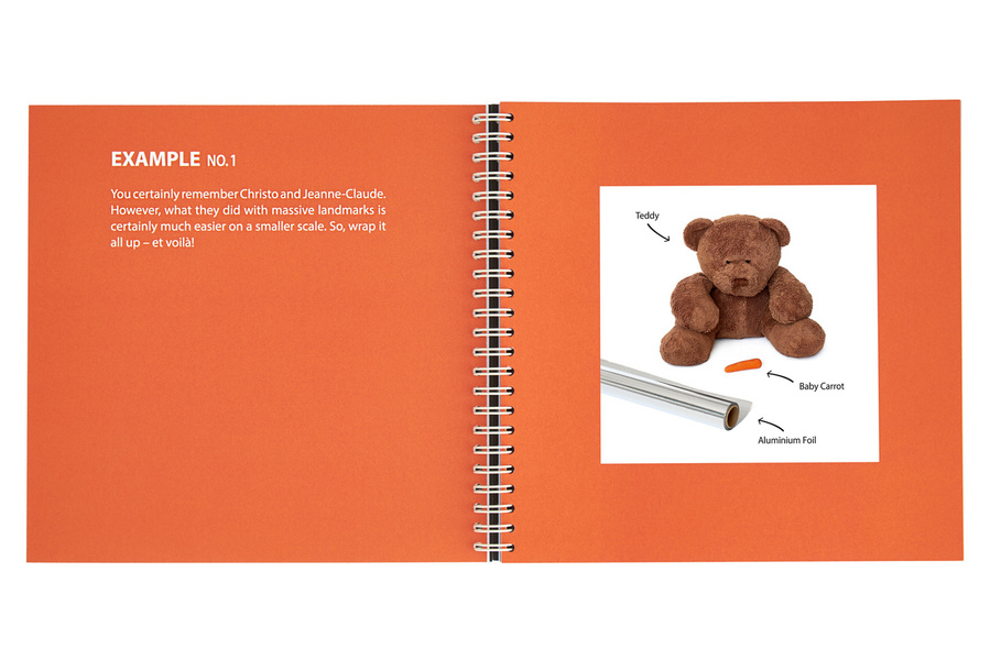 An open book with orange colored pages with a white text on the left and an image of a teddybear, a baby carrot and aluminum foil on the right page