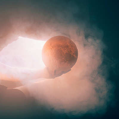 Photographic Art of A person holding a moon with smoke.