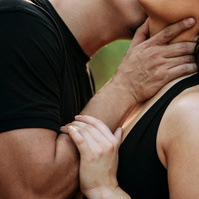 A newly engaged couple being playful and teasing each other.