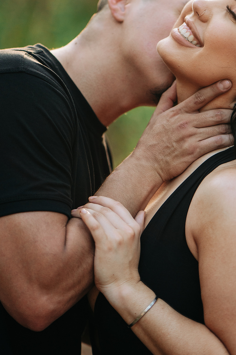 A newly engaged couple being playful and teasing each other.