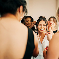 Bridesmaids helping their bride get ready before her ceremony in Houston, TX.