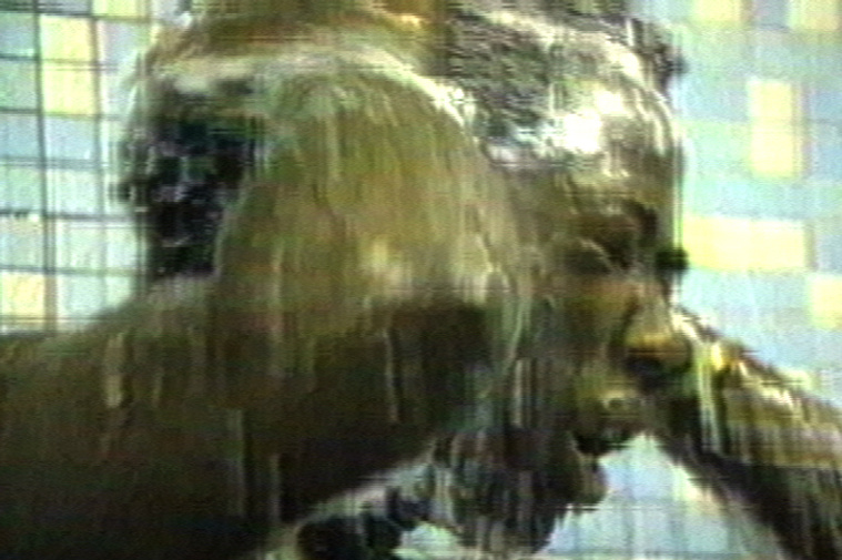 Pixelated image of a POC man washing his head in the shower.