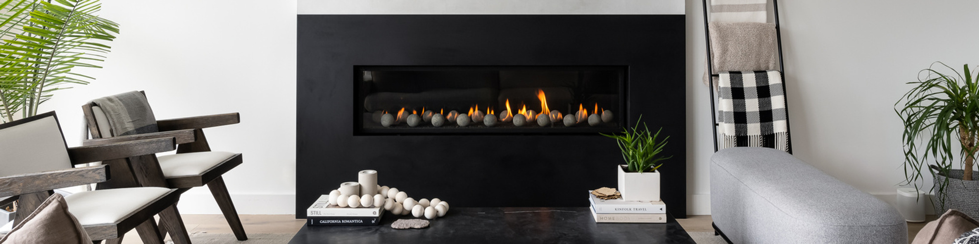A view at the black fireplace and a TV above it. Photograph by Taras Ivanitskii - Seattle based interior design and real estate photographer.