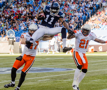 TORONTO, Ont. (06/08/2012) -  Toronto Argonauts Wide Receiver Dontrell Inman (11) jumps above _ and _ to catch a pass during game #11 against the B.C. Lions.   The Lions took the win 18 - 9.  Photo by Alicia Wynter, Toronto Argonauts.ca