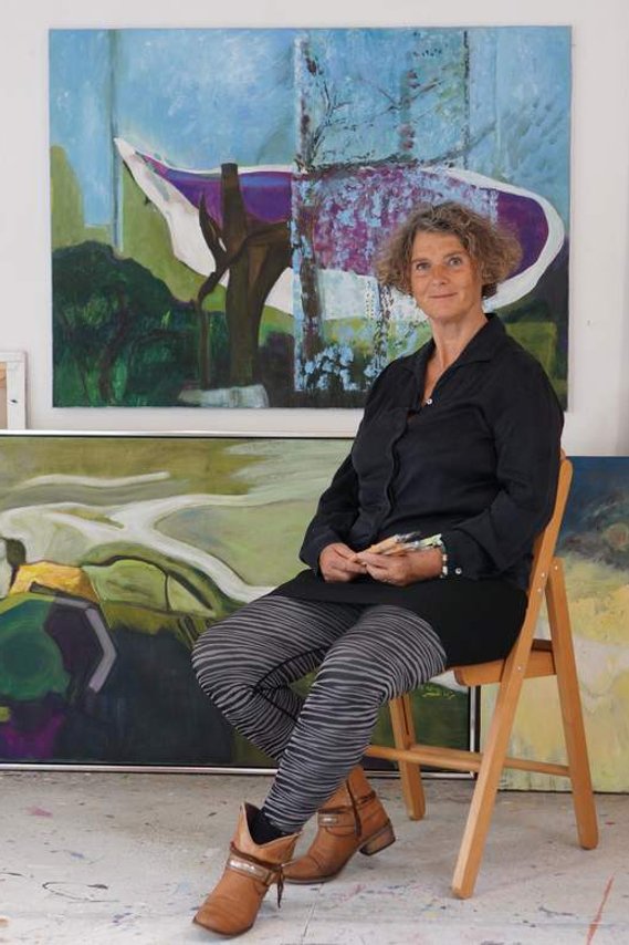 In the Studio Anna Wiesinger, surrounded by oilpaintings