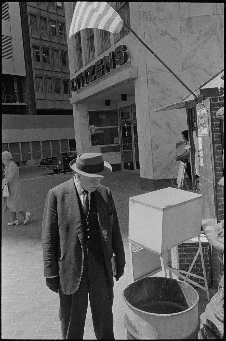 Nicholas Blair photography copyright 1977, black and white, San Francisco,  urbane life, man with bible