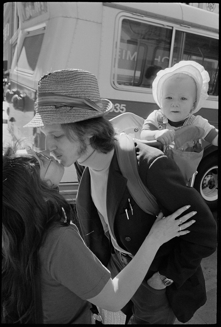 Nicholas Blair Photography copyright 1977, couple kissing with baby, black and white