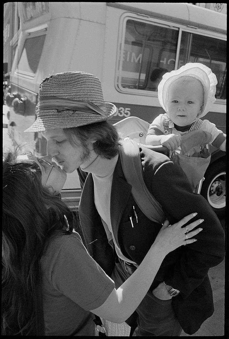 Nicholas Blair Photography copyright 1977, couple kissing with baby, black and white