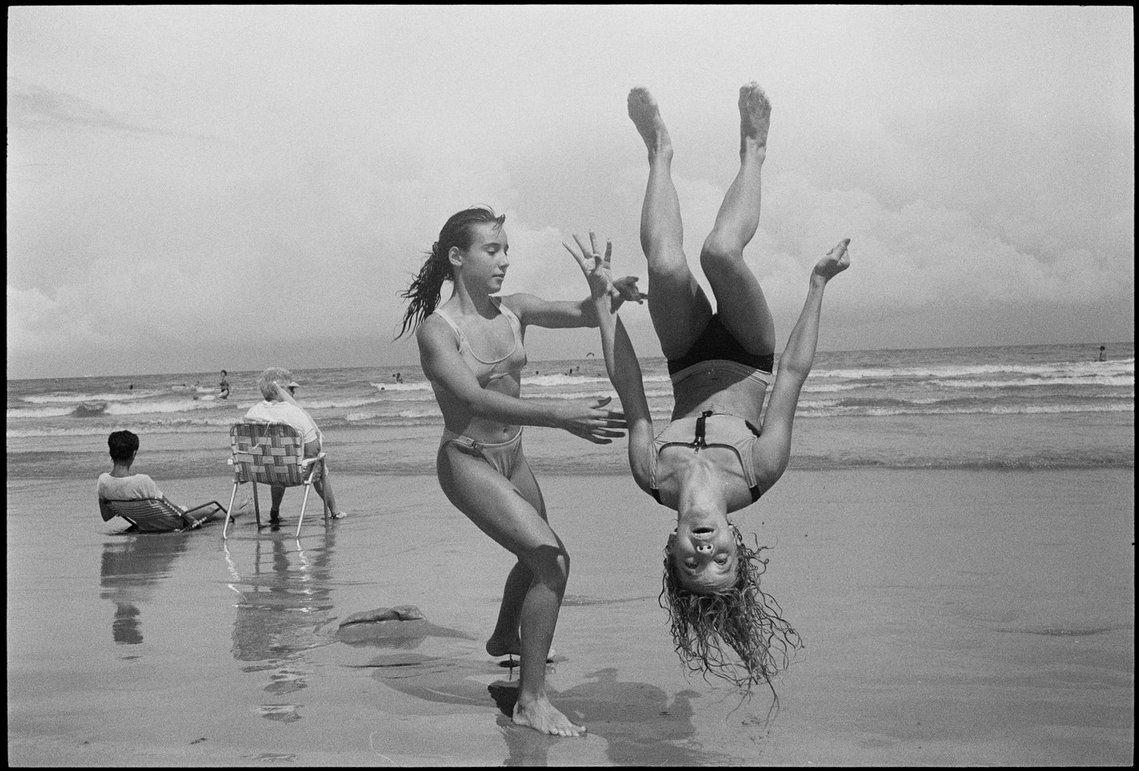 Nicholas Blair photography copyright 1977, black and white, Girl going flip, beach