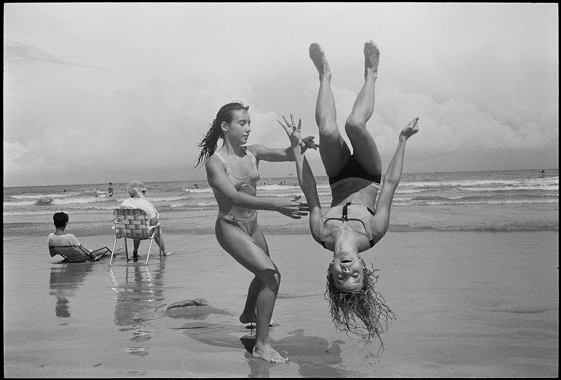 Nicholas Blair photography copyright 1977, black and white, Girl going flip, beach