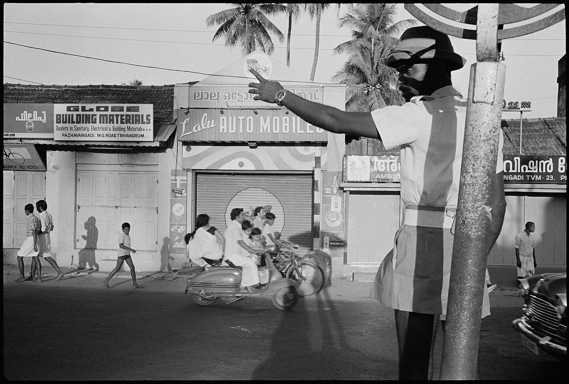 Nicholas Blair photography copyright 1978, black and white,Madras, Policeman, family on scooter