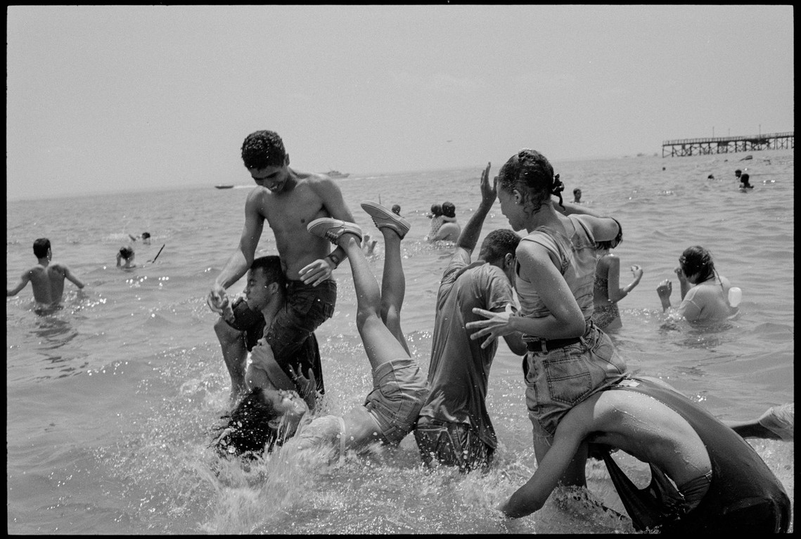 Nicholas Blair Photography copyright 1992, boys playing in surf, rough housing, black and white