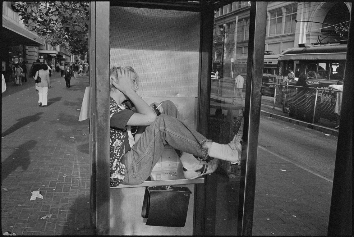 Nicholas Blair photography copyright 1977, black and white, San Francisco,  Person on telephone in distress, urban life