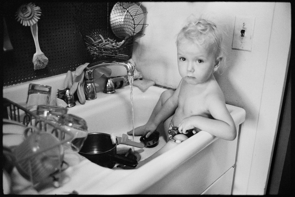 Nicholas Blair photography copyright 1982, black and white, toddler in sink
