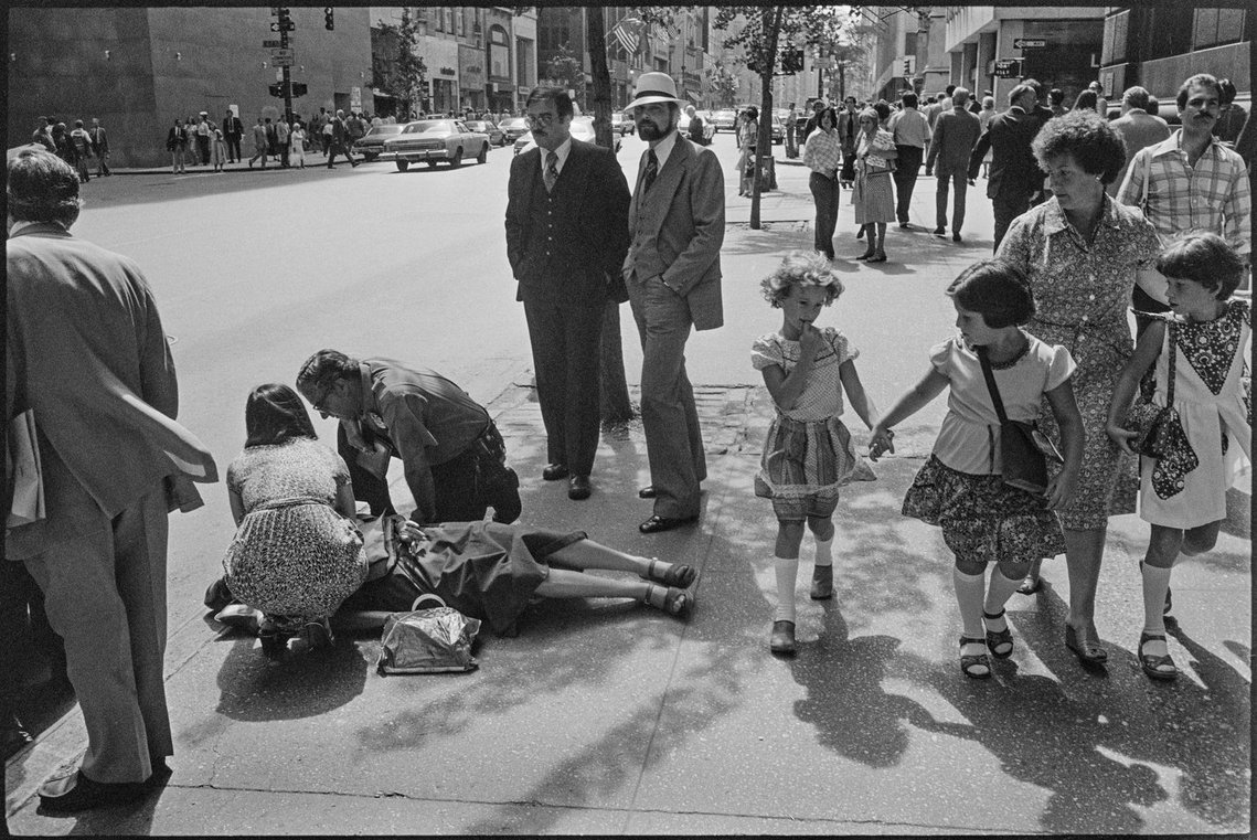 Nicholas Blair Photography copyright 1978, New York streets, urbane culture, woman lying on street, black and white