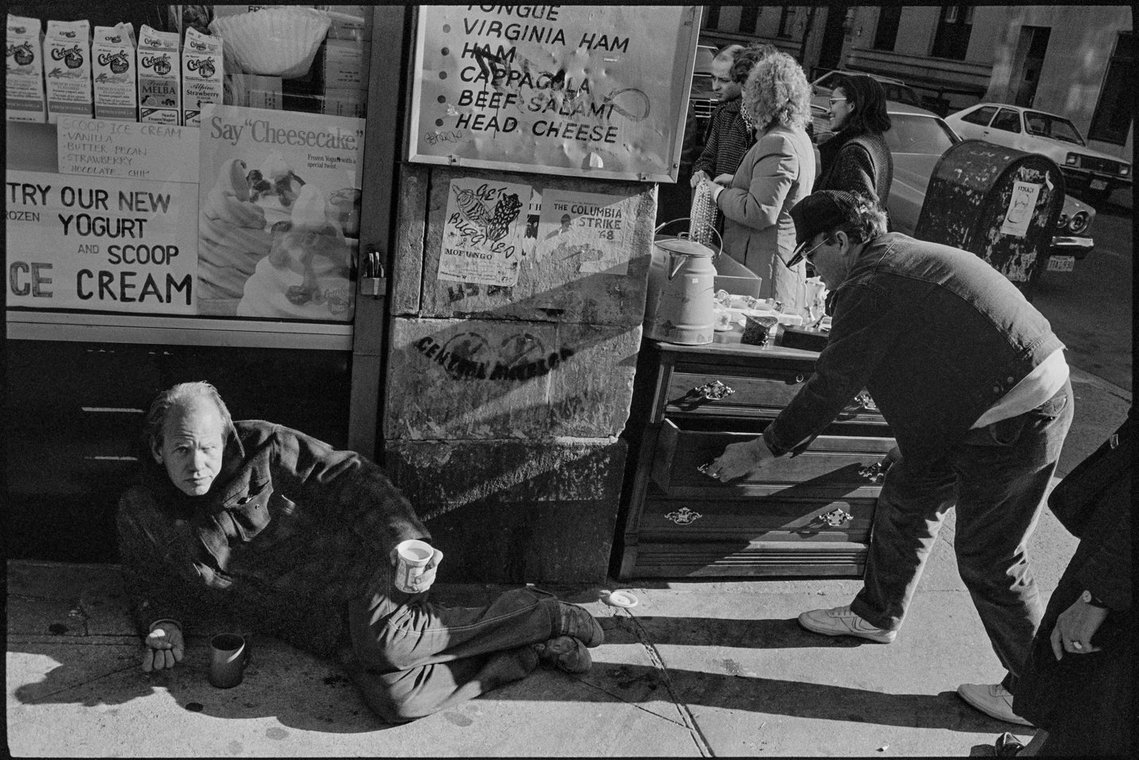 Nicholas Blair Photography copyright 1984, man lying on street, urban culture, black and white