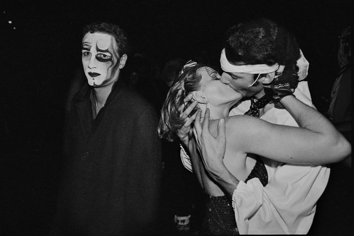 Nicholas Blair Photography copyright 1985, couple kissing, New Years Eve, man in face paint, black and white