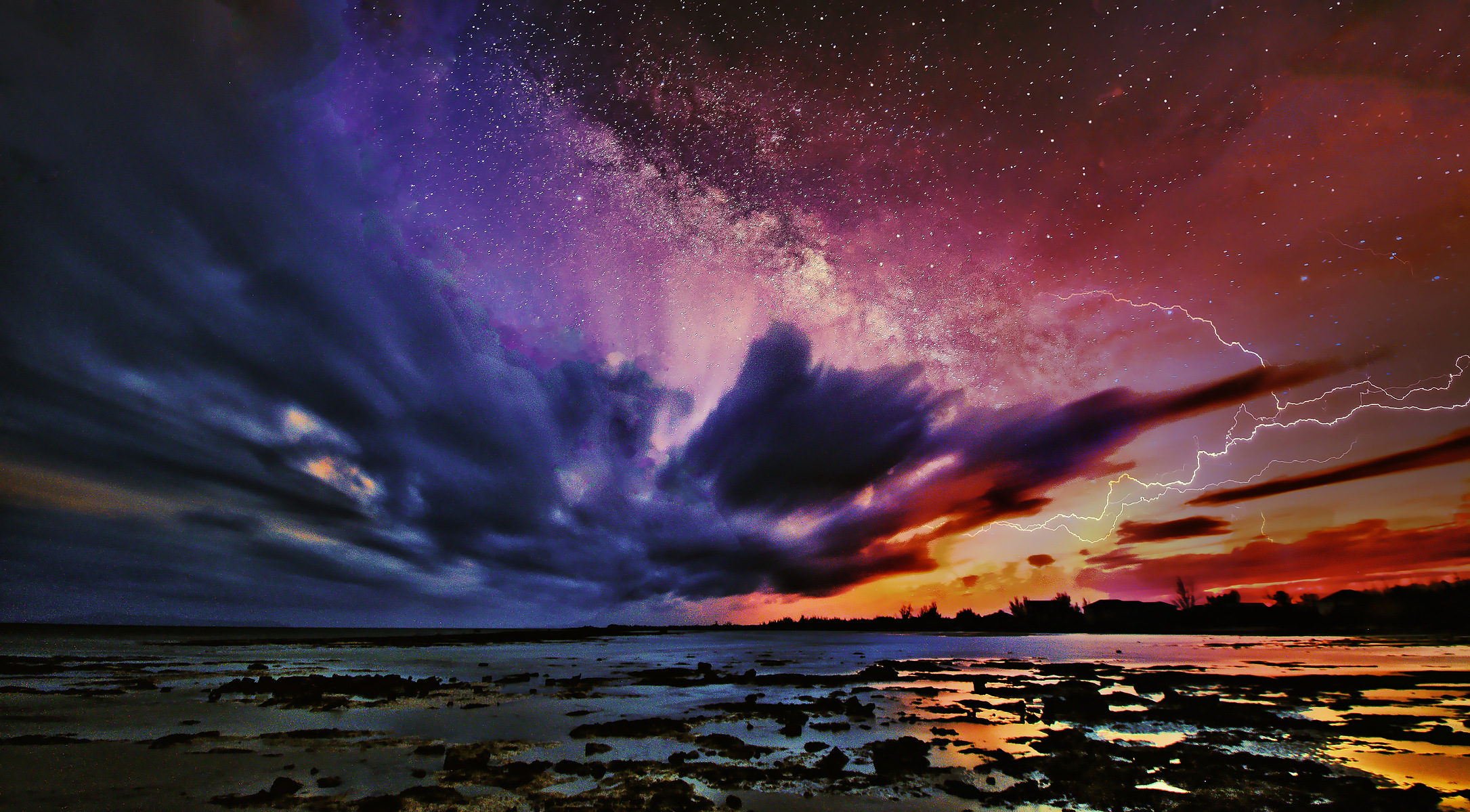 A breathtaking night sky glows with vibrant hues of purple, red, and orange, as lightning illuminates the horizon. Stars twinkle above a calm, reflective body of water, creating a dramatic contrast between the tranquil foreground and the dynamic celestial
