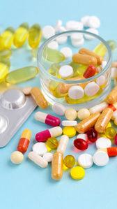 Vibrant blue background with multiple kinds of medications scattered around.