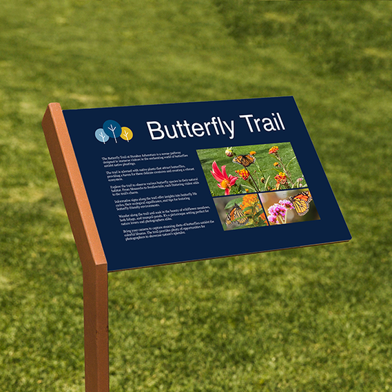 The image features an interpretive sign in the grass with a dark blue background. It includes the Humber logo, trail images, a description of the trail, and its history.