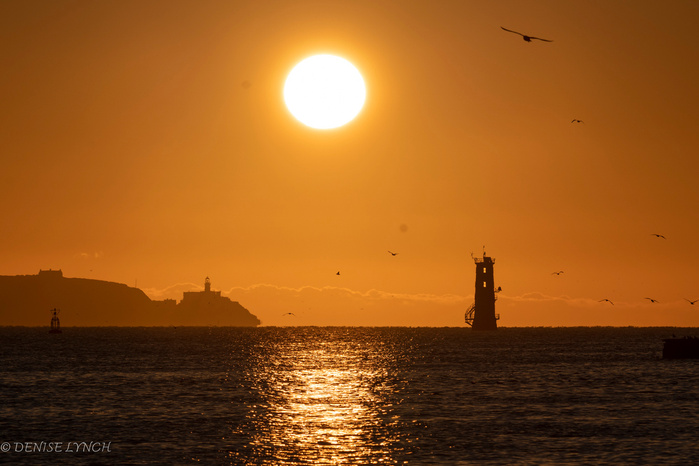 Sun Rising between Bailey Lighthouse & the Northbull Lighthouse