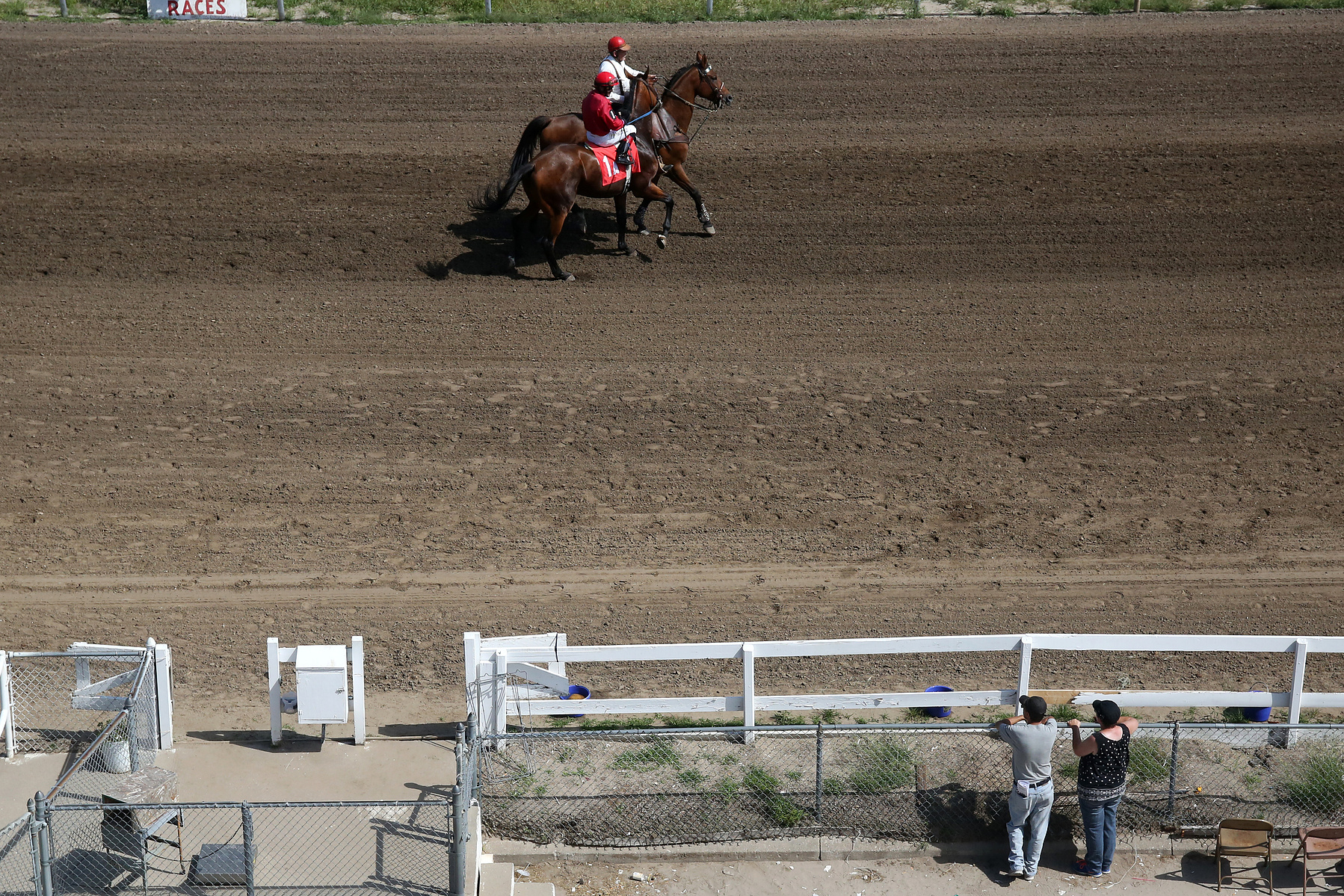 COLUMBUS, NEB - 9/6/2015 - In the second race of the day at AG Park on Saturday Recrank ridden by Nathan Haar is led onto the race for a warm up sprint by an outrider. JENNA VONHOFE/Lincoln Journal Star