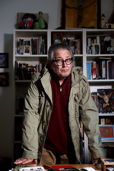 Israel Centeno stands at his desk, Tuesday, Feb. 4, 2025, at his apartment in North Side. Centeno arrived in Pittsburgh 15 years ago after being exiled from his home in 