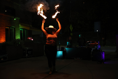Symphany Valencia performers her last fire performance of the night, Friday, Nov. 1, 2024, at Burghers Brewery in South Side. (Photo by Anastasia Busby/PublicSource)