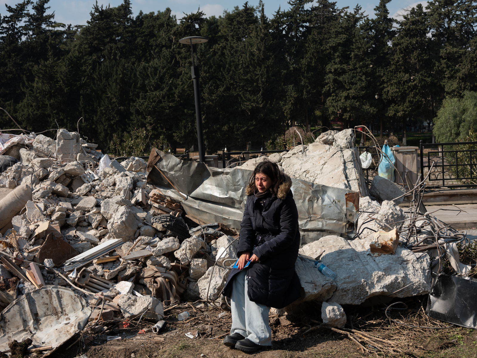 As the search and rescue effort continues, a woman cries, holding the photo of her father, next to the ruins of his former home, destroyed by the double earthquakes that hit the 6th of February 2023.
