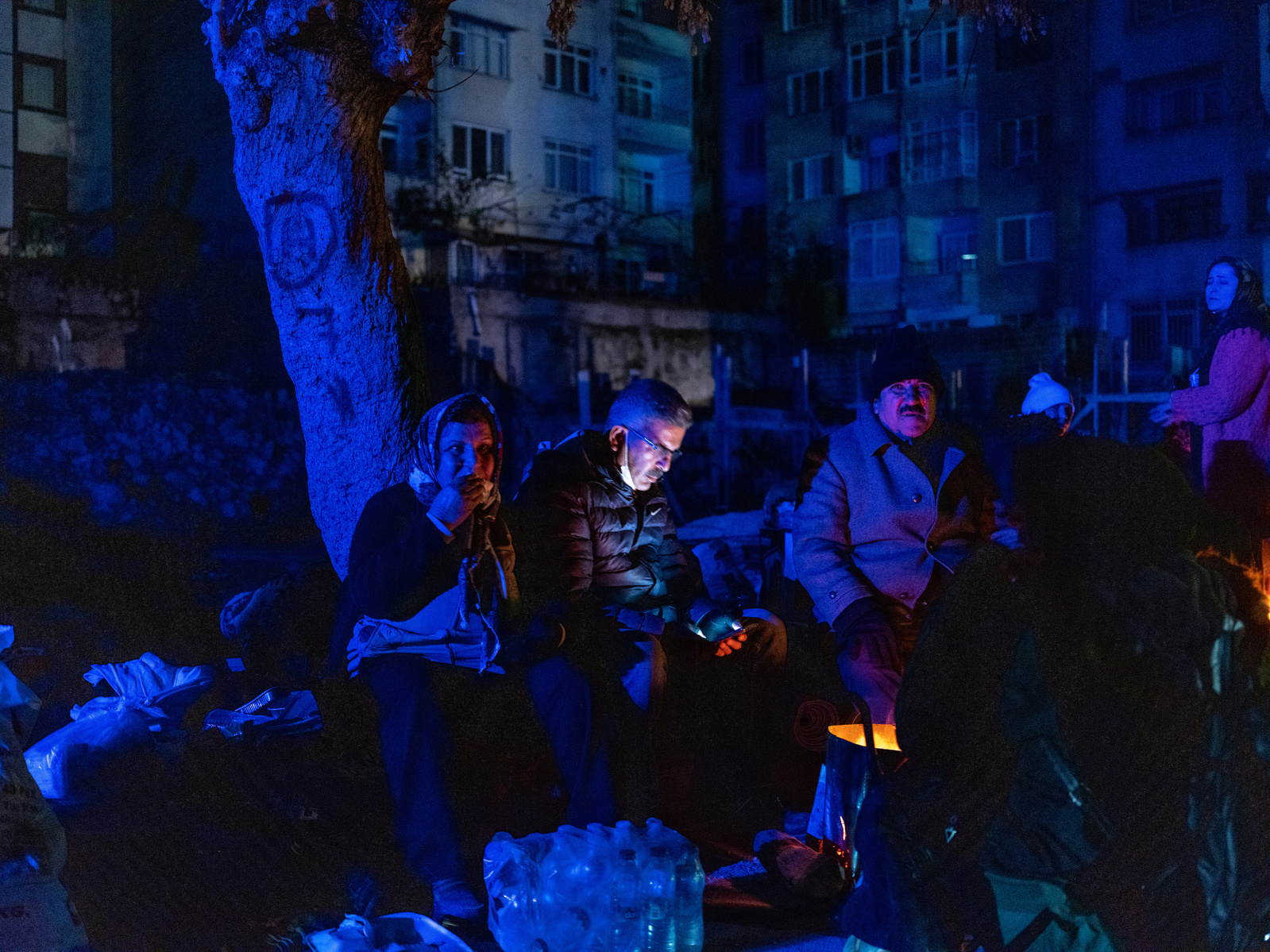 Watching on with hope - former residents of apartment blocks destroyed by the earthquake, wait next to rescue workers, for news on their loved ones, and sleep outside at night after the vast majority of homes/buildings became unsafe.