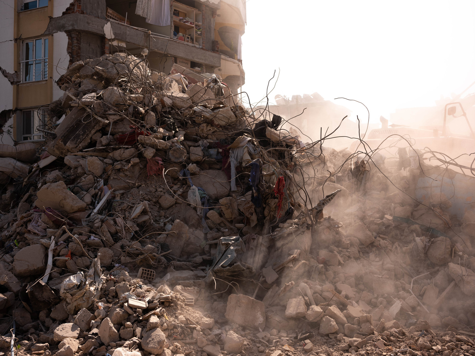 Diggers sift through the rubble of destroyed buildings after two large earthquakes killed tens of thousands of people in southern Turkey on 6th of February 2023. After sear and rescue efforts drawed to a close, the reconstruction process began again.