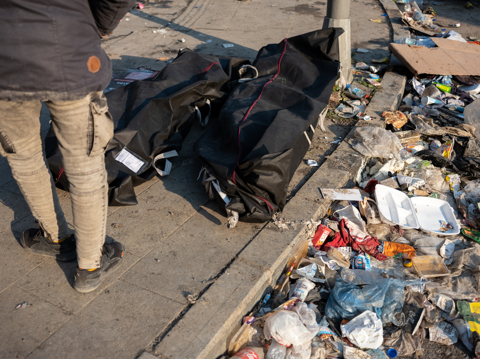 The bodies of two victims of Monday’s earthquake lay on the side of the road at night, alongside hundreds of others in Antakya, Turkey, where severe devastation was caused by the two large earthquakes on the 6th of February 2023.