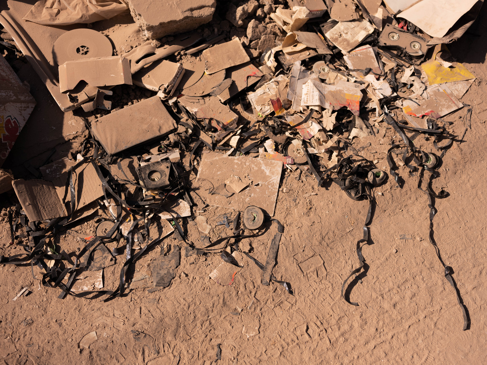 Possessions and memories strewn across the dusty streets, next to collapsed buildings in Hatay, Turkey.