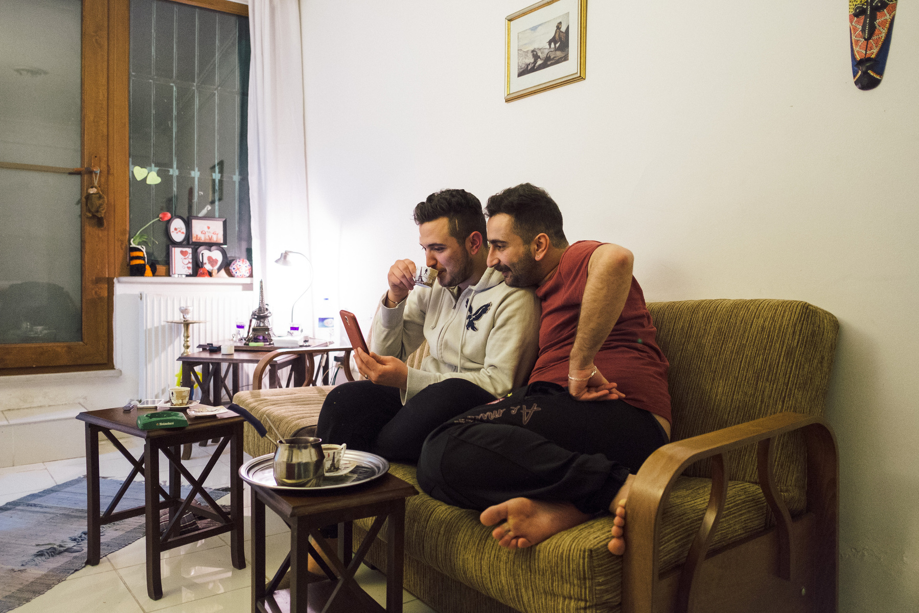 Istanbul, Turkey. At home, partners Nader (right) and Omar (left) talk to Omar's mother on the eve of Nader's departure to Norway where he has been granted political asylum. the couple share an apartment in central Istanbul.
