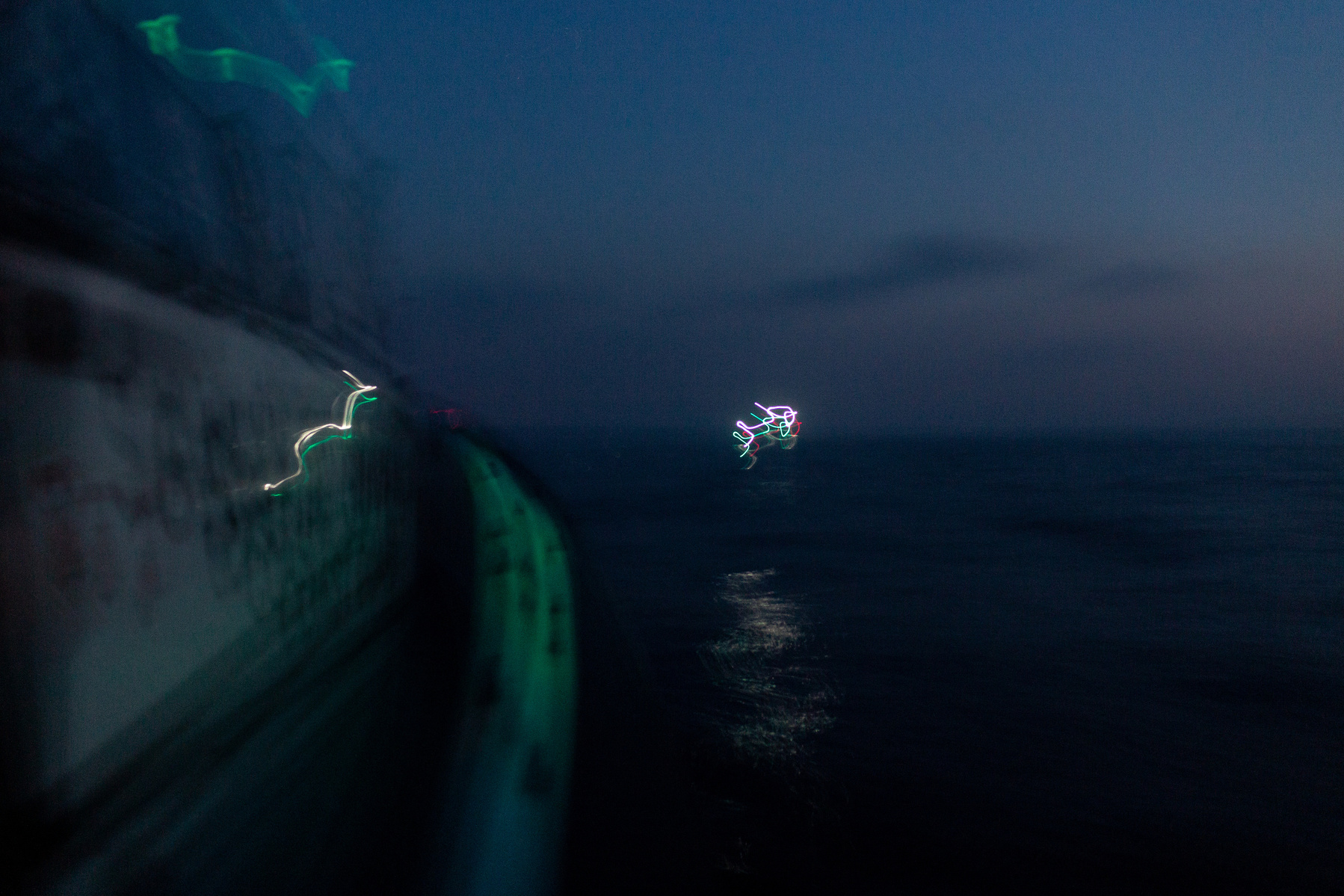 The waters of the northern Aegean Sea are lit by the lights on a Turkish coastguard boat en route to a rescue operation in the early hours of the morning.