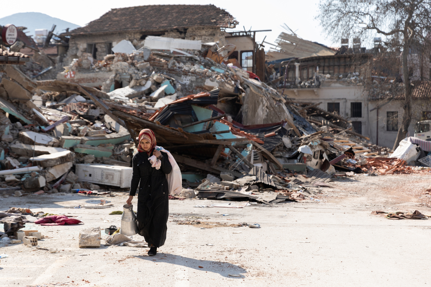 Passing by the ruins of the destroyed city of Antakya, southern Turkey, residents pass the bodies of victims retrieved from the rubble, and the ruins of their beloved city, as they navigate the accessible roads after the double earthquake in the south of
