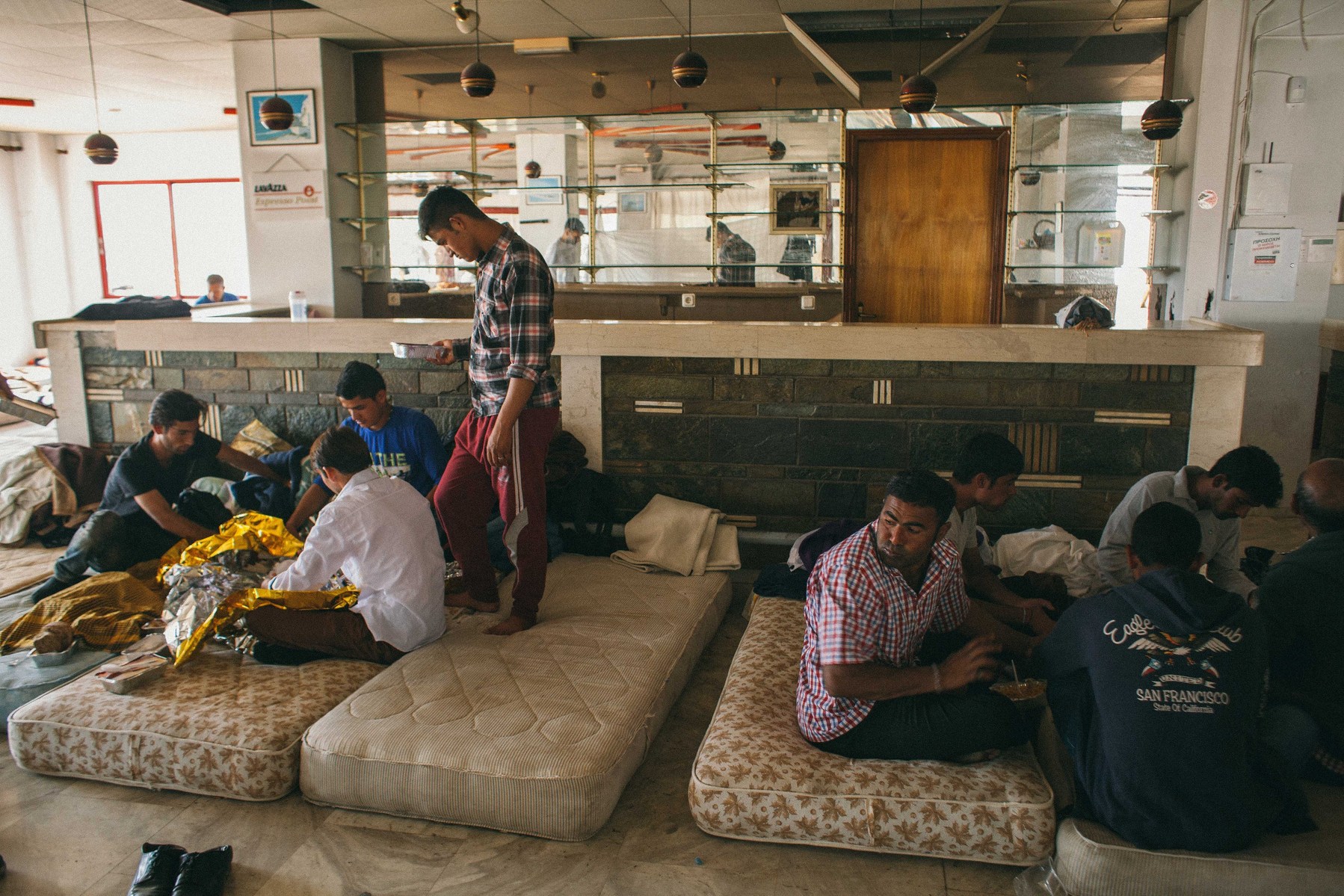 The reception of the long closed Hotel Captain Elias on the Greek island of Kos. Hundreds of migrants sleep in the hotel's few rooms, reception, terrace and outisde in the grounds around the swiming pool.