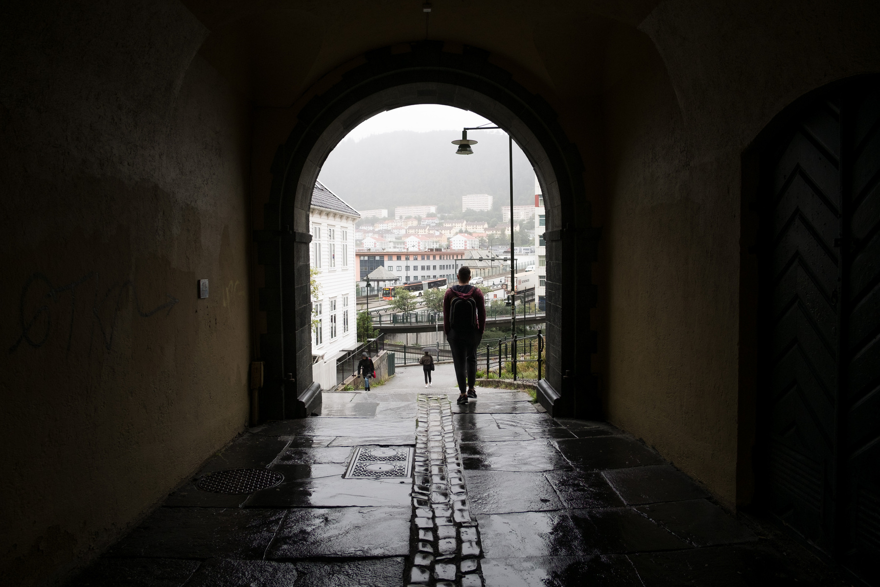 En route to the refugee introduction course Omar walks through a passage to meet his partner Nader who just took a Norwegian language exam.