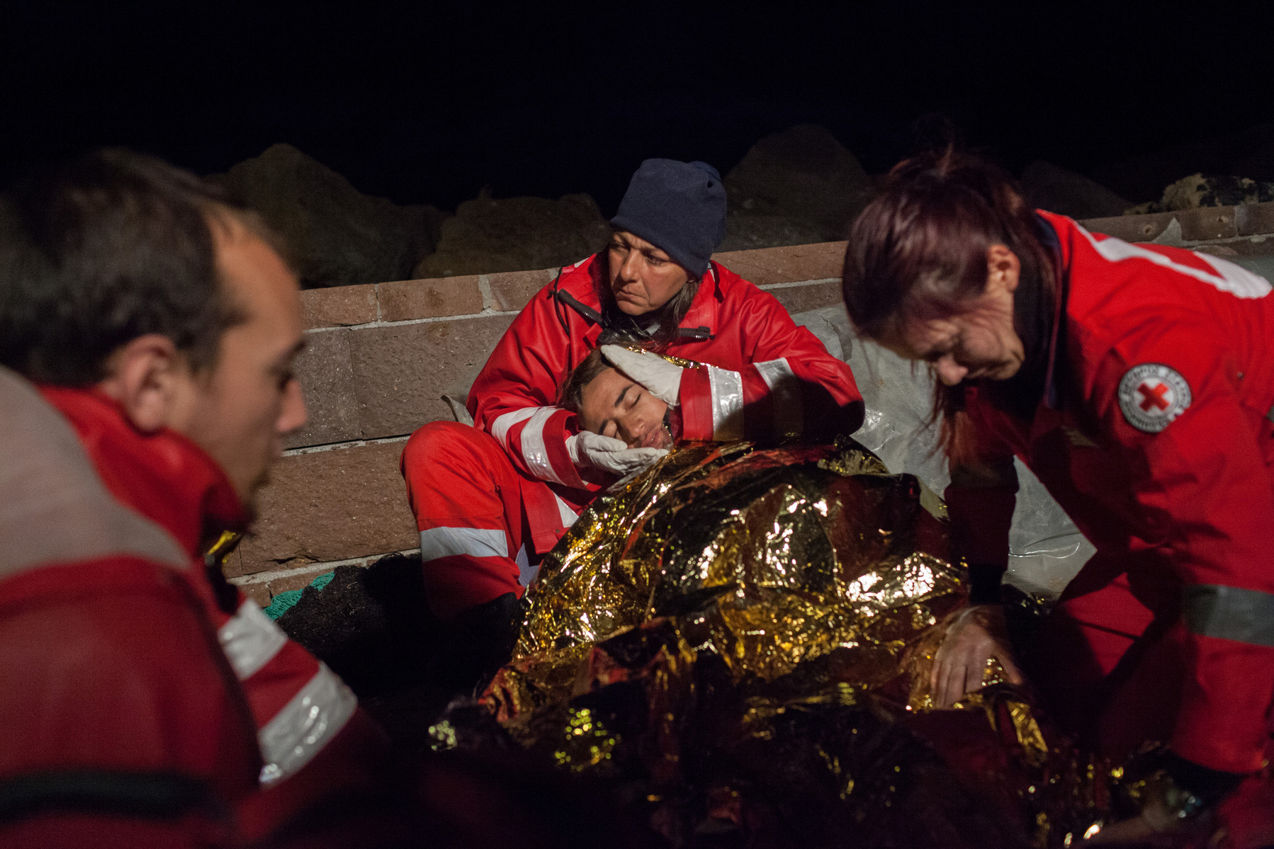 The Hellenic Red Cross treat an Afghan man after the boat he was using to enter Greece from Turkey had engine trouble, and he spend three hours at sea in cold temperatures. Molyvos harbour, Lesvos island, Greece.