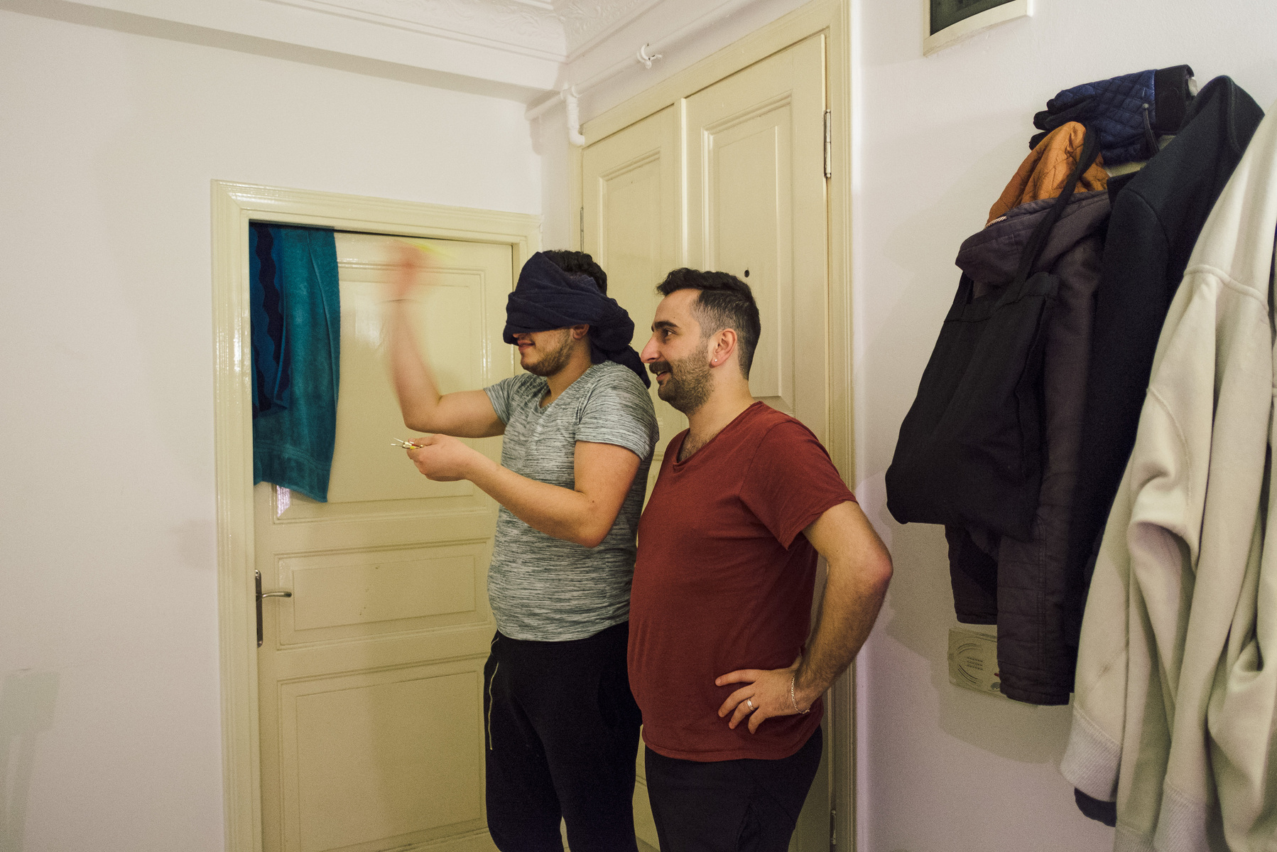 Omar (left) throws a dart at home with his partner Nader. The two Syrians lived together in Turkey for almost a year, until tomorrow when Nader departs for Bergen, Norway, where he has been granted political asylum.