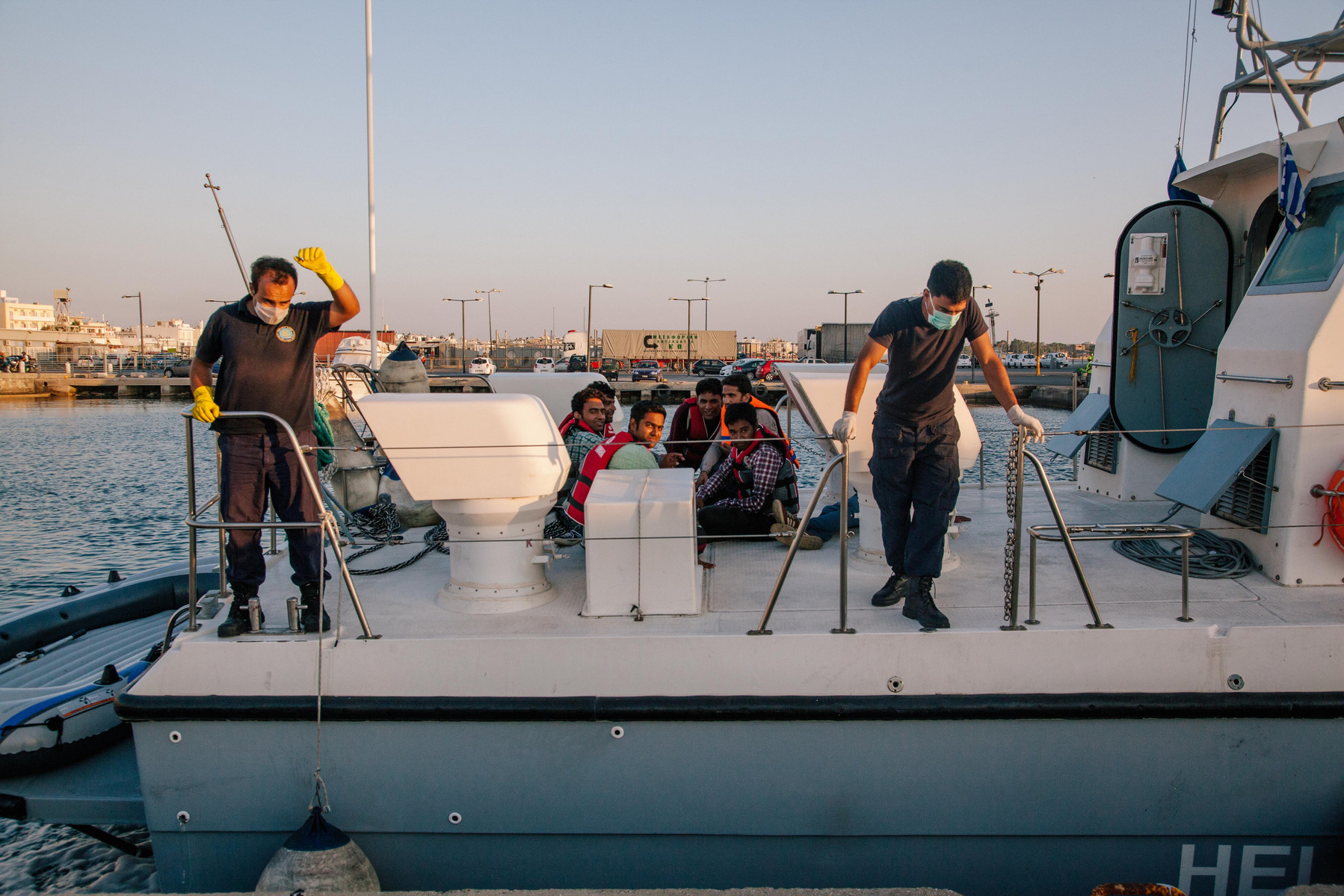 Seven Pakistani men that were found in Greek waters, paddling from Turkey, that were rescued by the Hellenic Coastguard arrive on European soil at the Greek port of Kos.