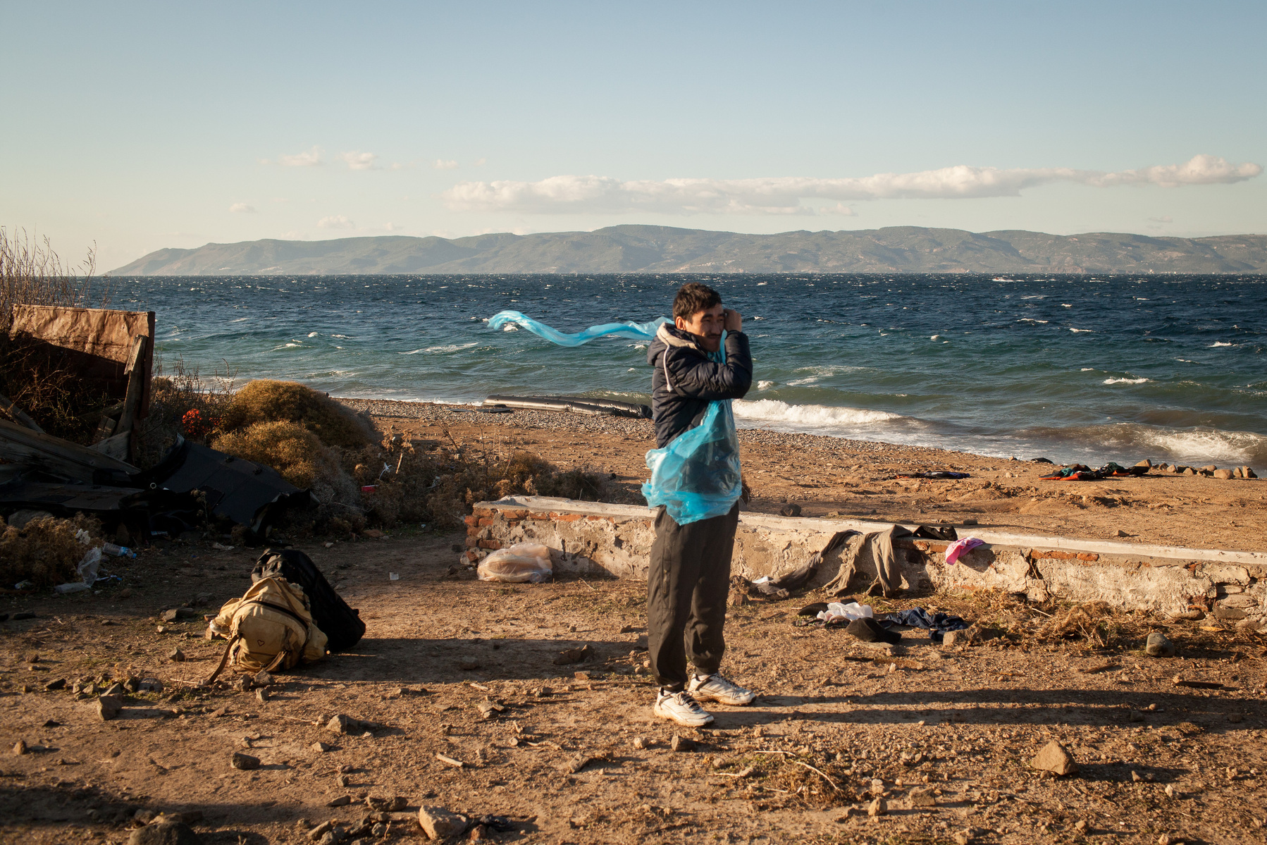 An Afghan man stands on a beach near Molyvos, Lesvos island in Greece after just arriving from Turkey on a rubber dinghy.
