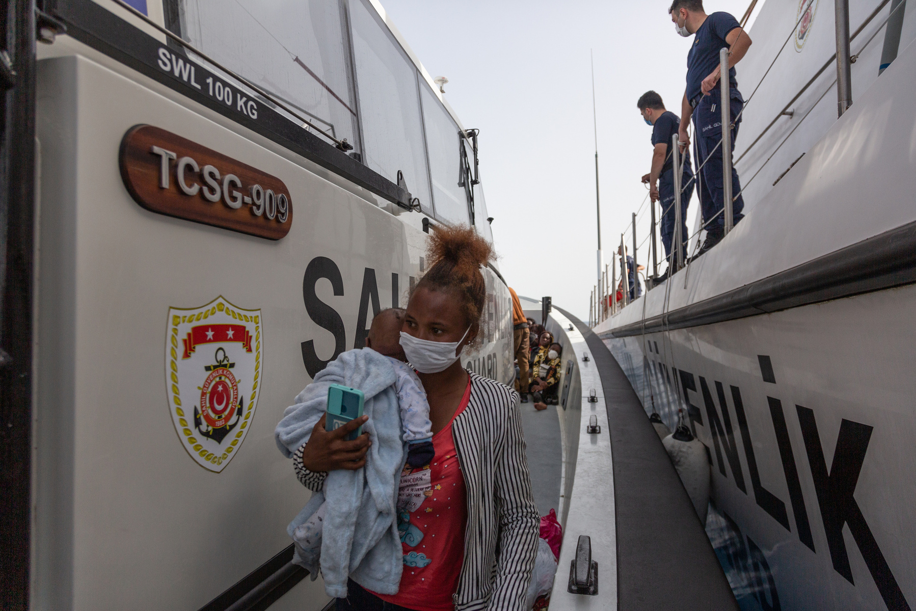 Sabi, and her one month old son Mahmoud, from Guinea, on a Turkish coastguard boat after being rescued from an inflatable raft which drifted in the Aegean Sea for at least 17 hours.