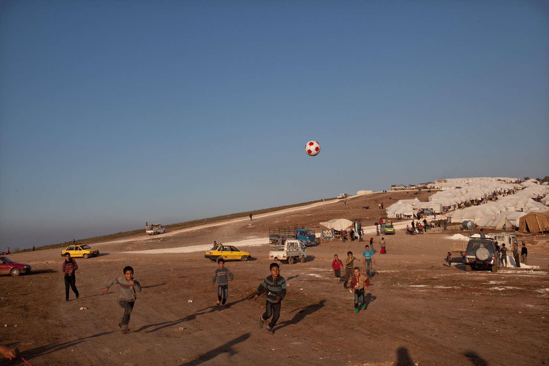Children play football in the displacement camp in Atmeh, on Syria's border with Turkey. Around 12,000 IDP now live in the camp. December 2nd 2012, Atmeh, Syria.