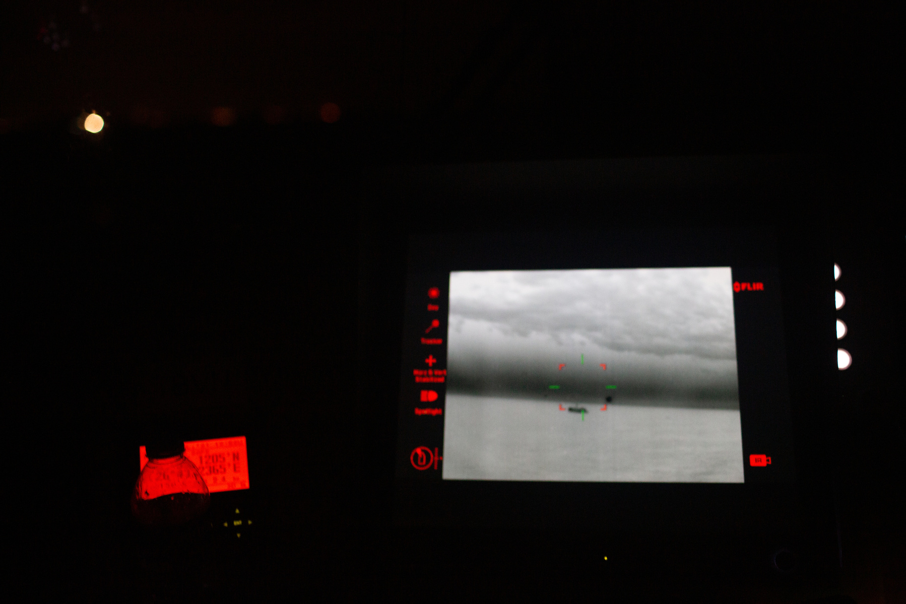 Europe, Turkey, northern Aegean Sea. Turkish coastguard prepare for a rescue operation of migrants drifting in the open water at night, using thermal imaging cameras to help locate them.